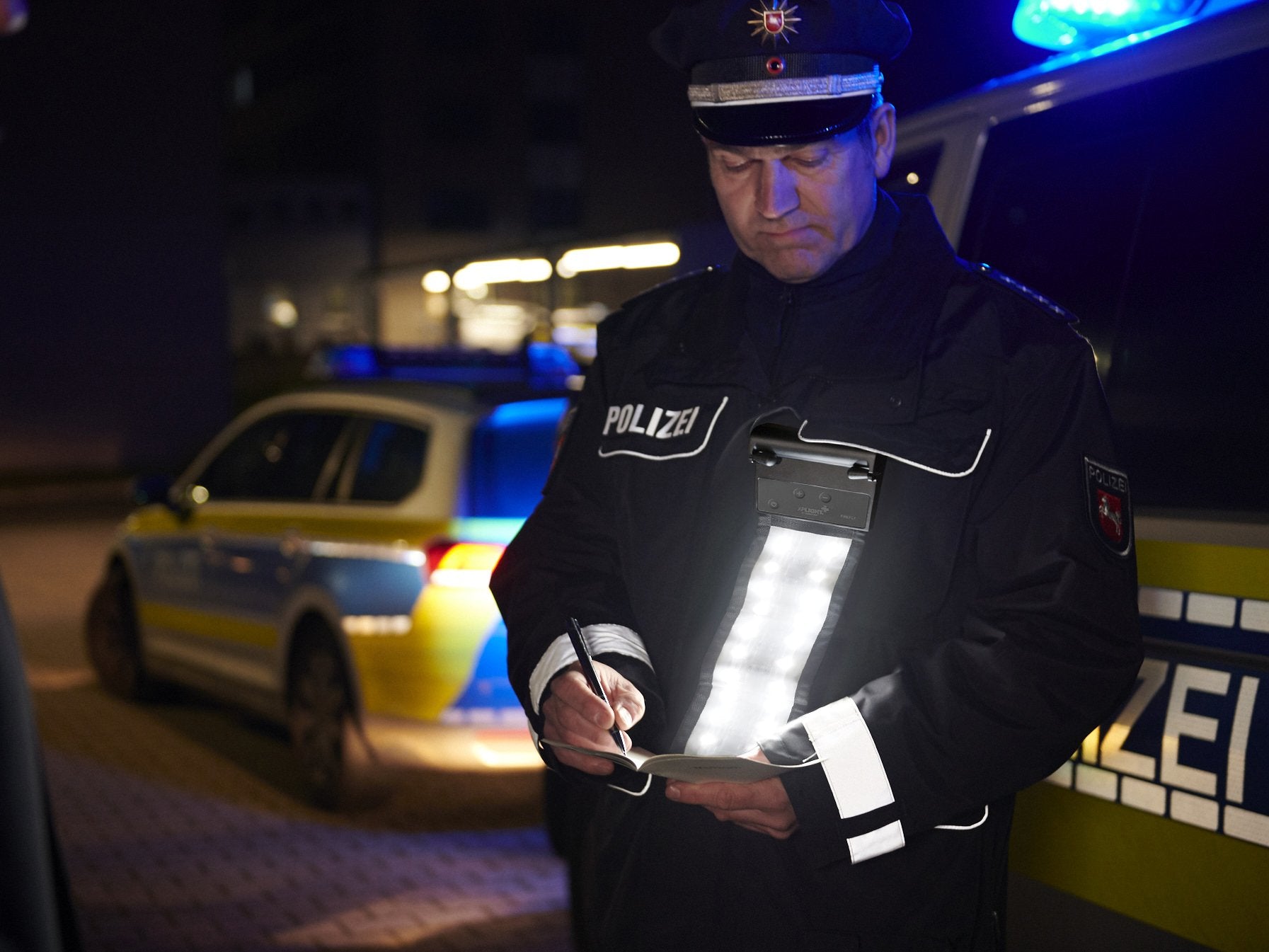 Police officer with XP FIREFLY on his uniform during a document check